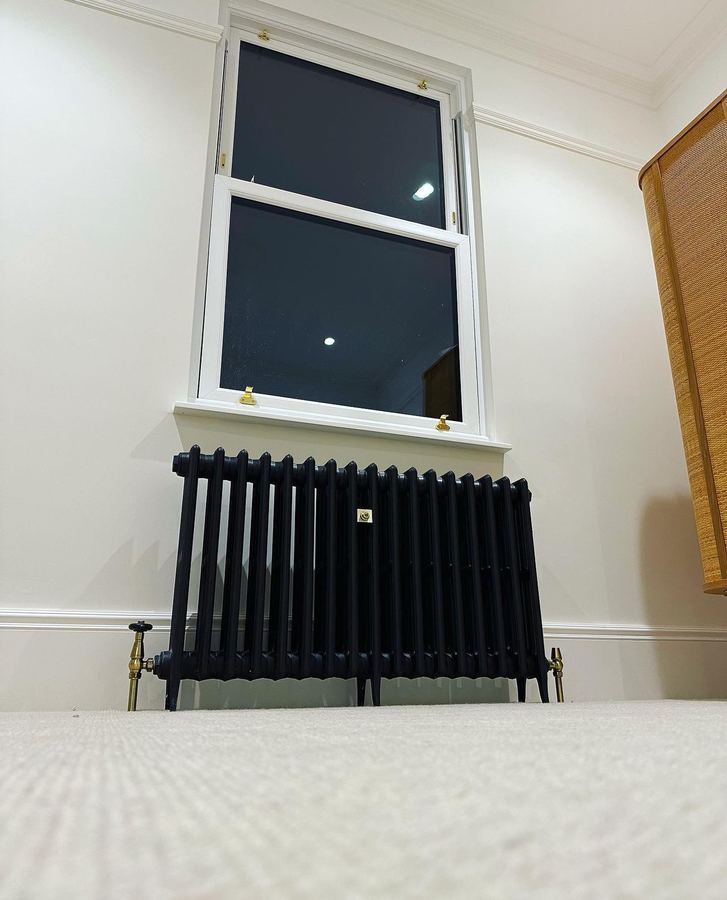 Traditional radiator under a sash window
