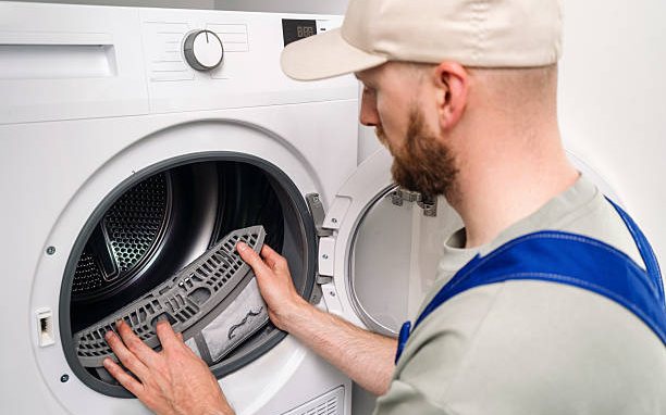 Tumble dryer filter being checked