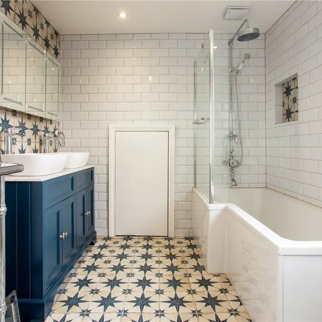 Metro tiled bathroom with navy vanity and star-patterned floor