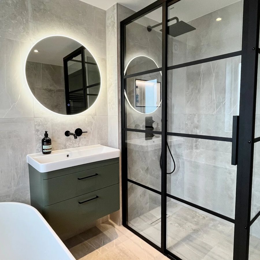 Marble-effect bathroom with green vanity unit and Crittall shower enclosure