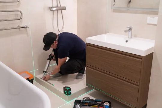 Shower tray being sealed in with a laser level set up