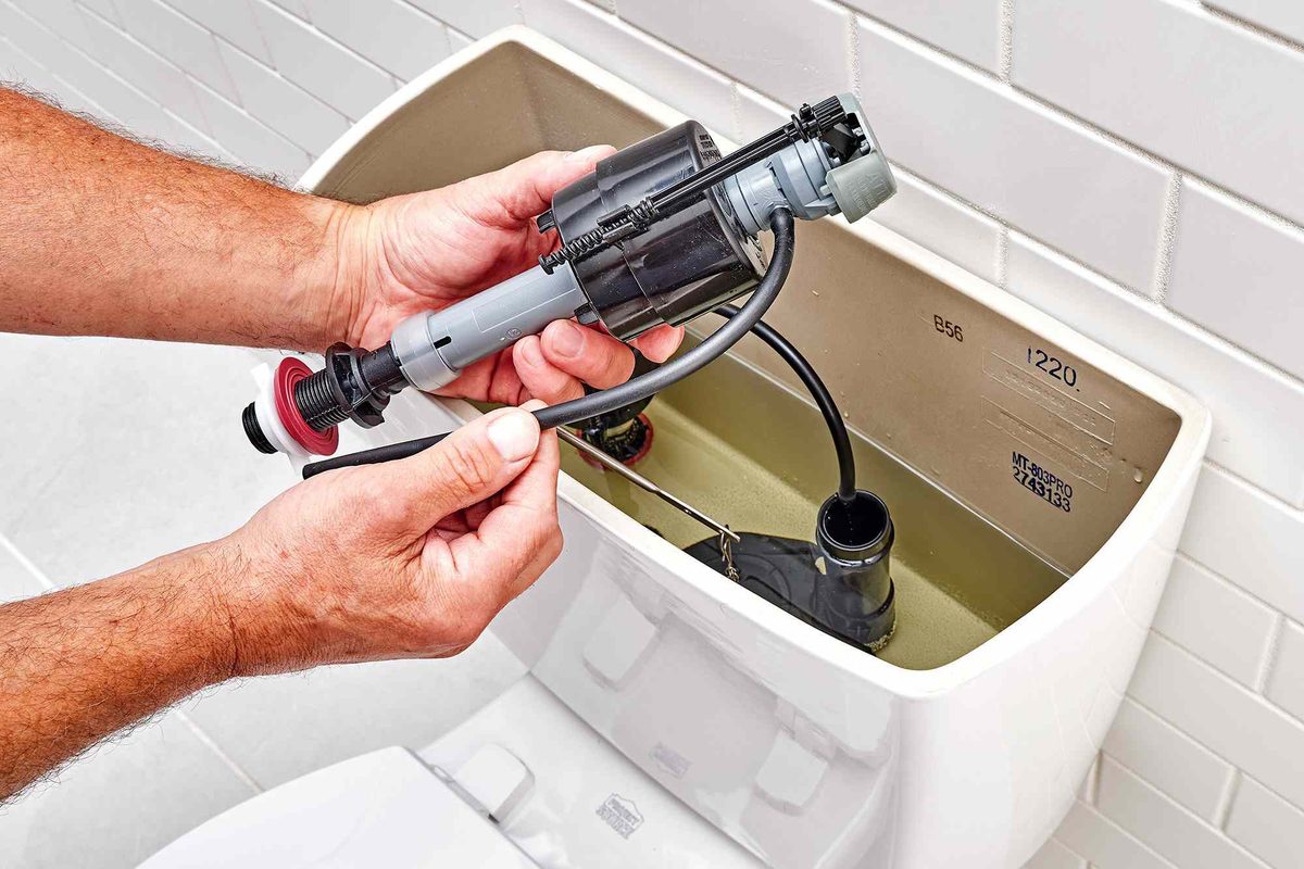 Replacement fill valve being fitted into a toilet cistern
