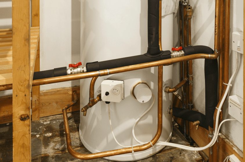 Indirect cylinder with its thermostat, motorised valves and pipework exposed for fault finding