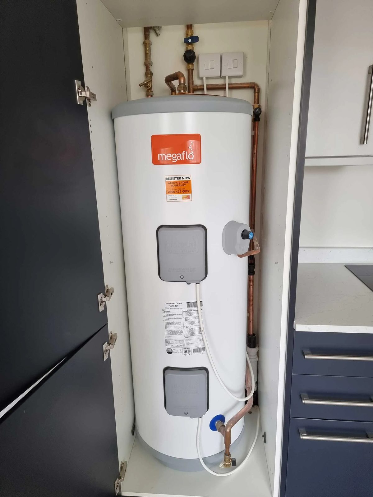 Megaflo unvented direct cylinder fitted inside a tall kitchen cupboard